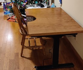 Finished wooden desktop installed on standing desk base